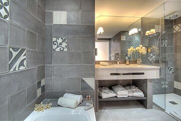 A bathroom with a bathtub a sink and a mirror