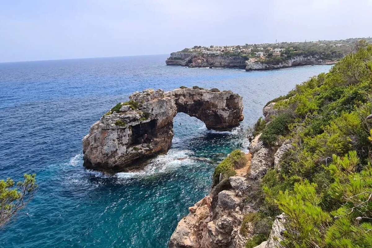 A large rock in the middle of a body of water