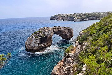A large rock in the middle of a body of water