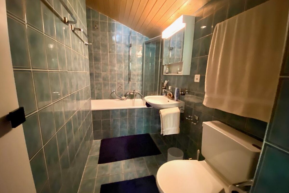 A bathroom with a toilet a sink and a bathtub