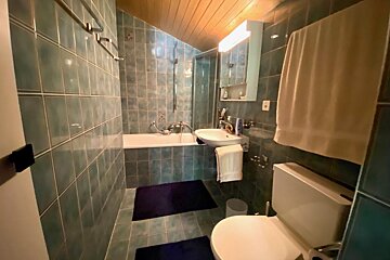 A bathroom with a toilet a sink and a bathtub