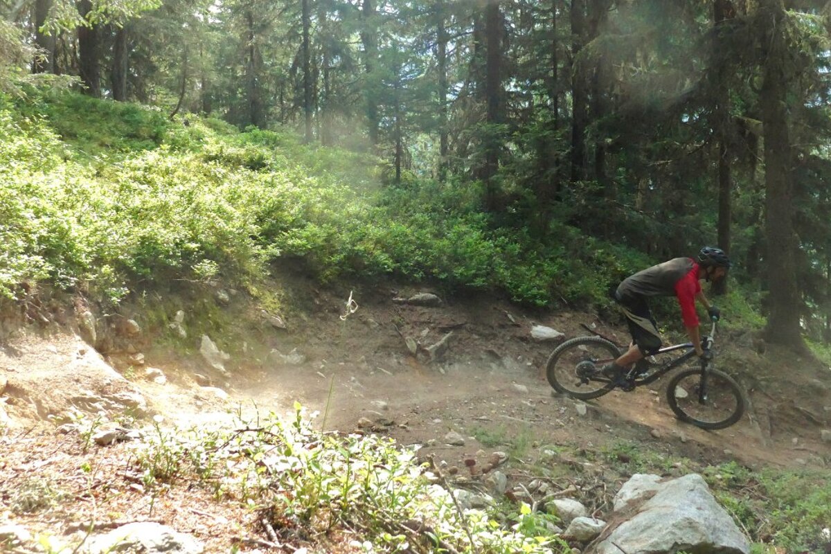 a mountain biker on a rocky corner on a DH track in vallorcine