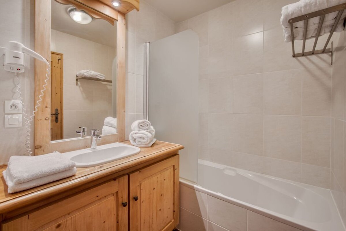 A bathroom with a sink a mirror and a bathtub