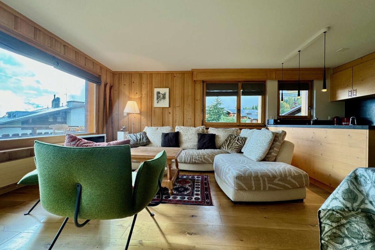 A living room with a couch and a green chair