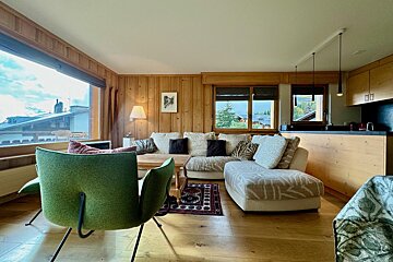 A living room with a couch and a green chair