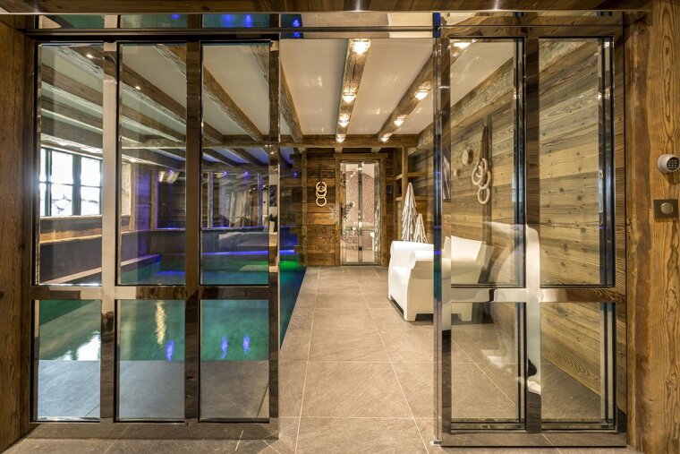 A sliding glass door leads to a swimming pool