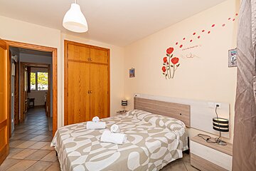 A bedroom with a bed and a sticker on the wall that says