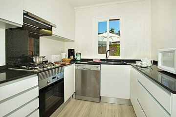 A kitchen with stainless steel appliances and white cabinets