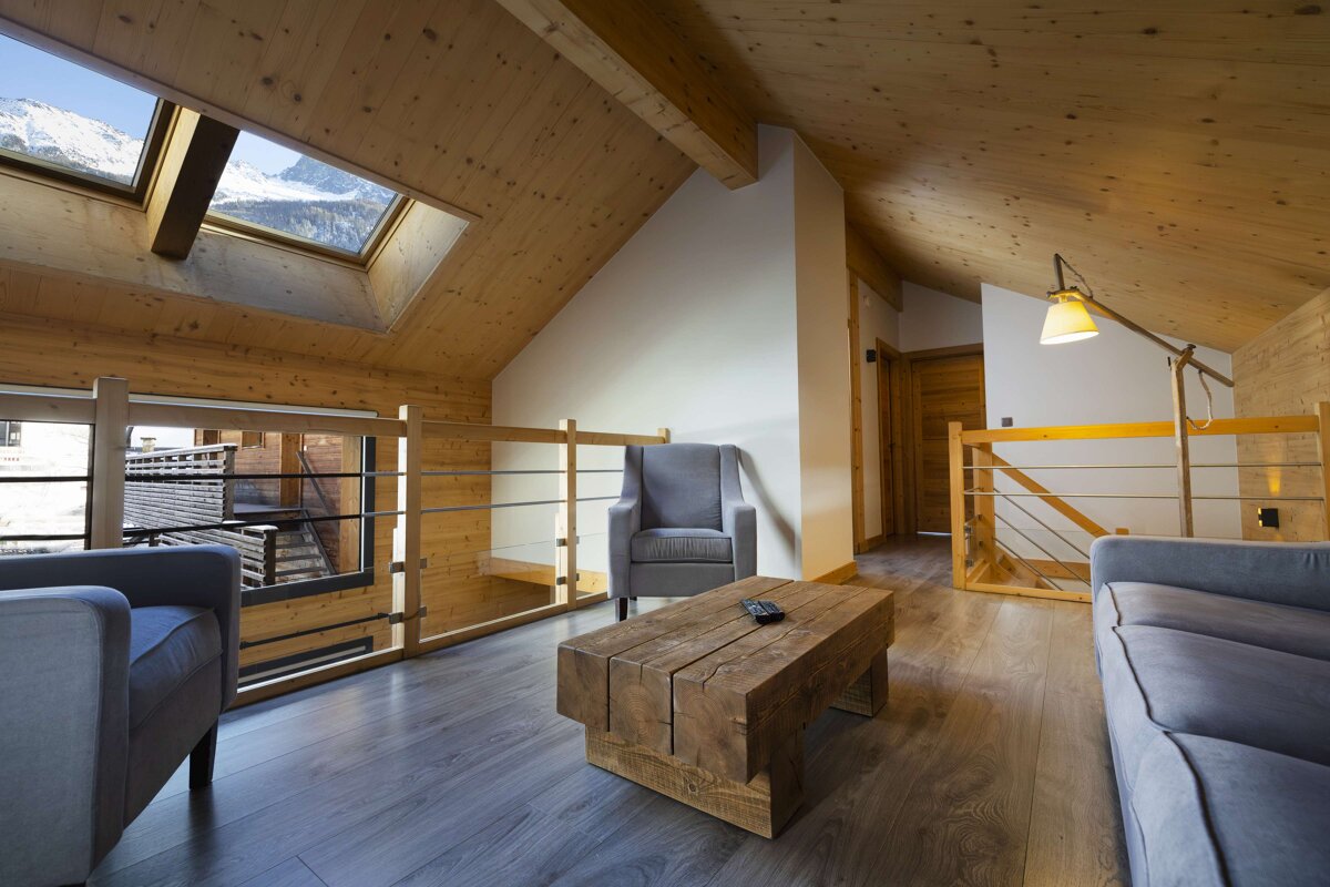 A living room with a couch a chair and a table