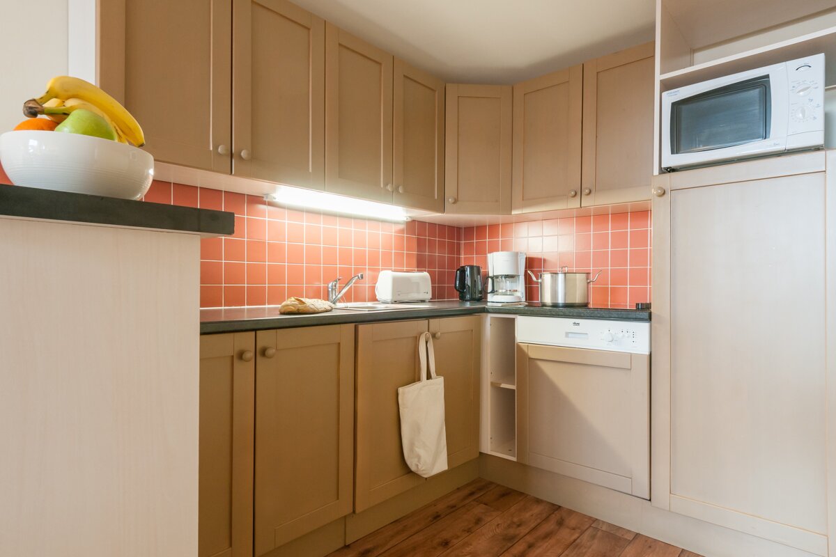 A kitchen with a microwave and a toaster oven