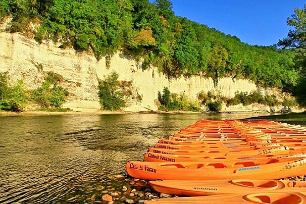 people rafting on canoes on a river