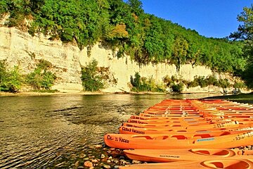 people rafting on canoes on a river