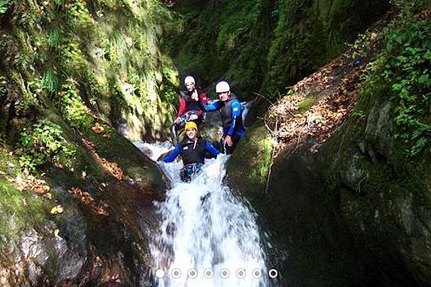 A group of people are sliding down a waterfall