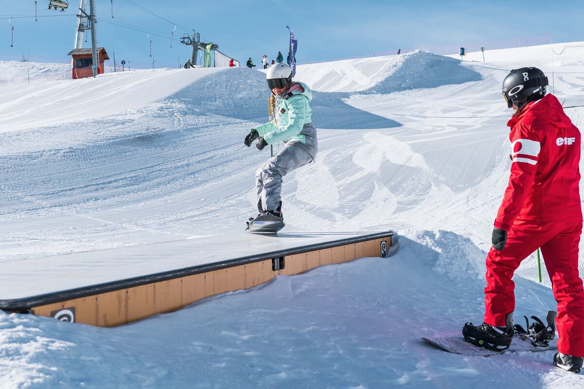 A snowboarder wearing a helmet that says r on it