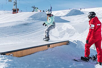 A snowboarder wearing a helmet that says r on it