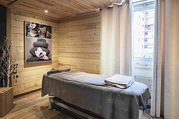 A massage table in a room with a painting on the wall