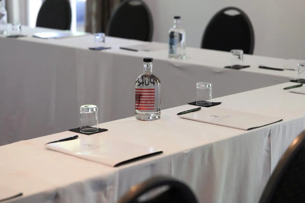 A bottle of aquafina water sits on a conference table