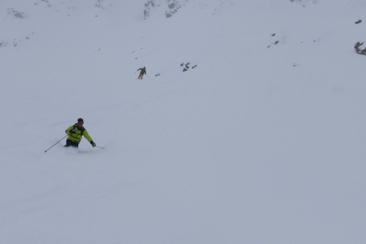 a skier in a yellow jacket