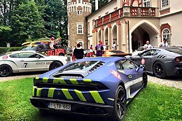 a supercar outside a chateau