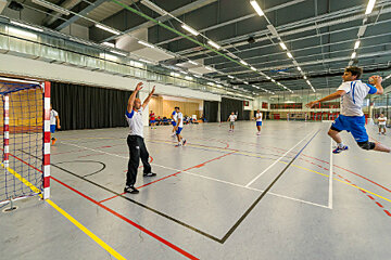 A group of people are playing a game of handball
