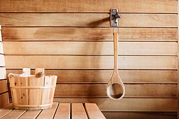 A wooden bucket and a wooden ladle in a sauna
