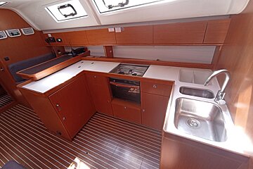 A kitchen with a stove top oven and a sink