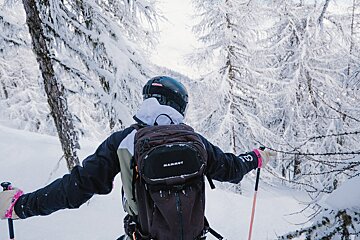 A person with a backpack that says mammut on it