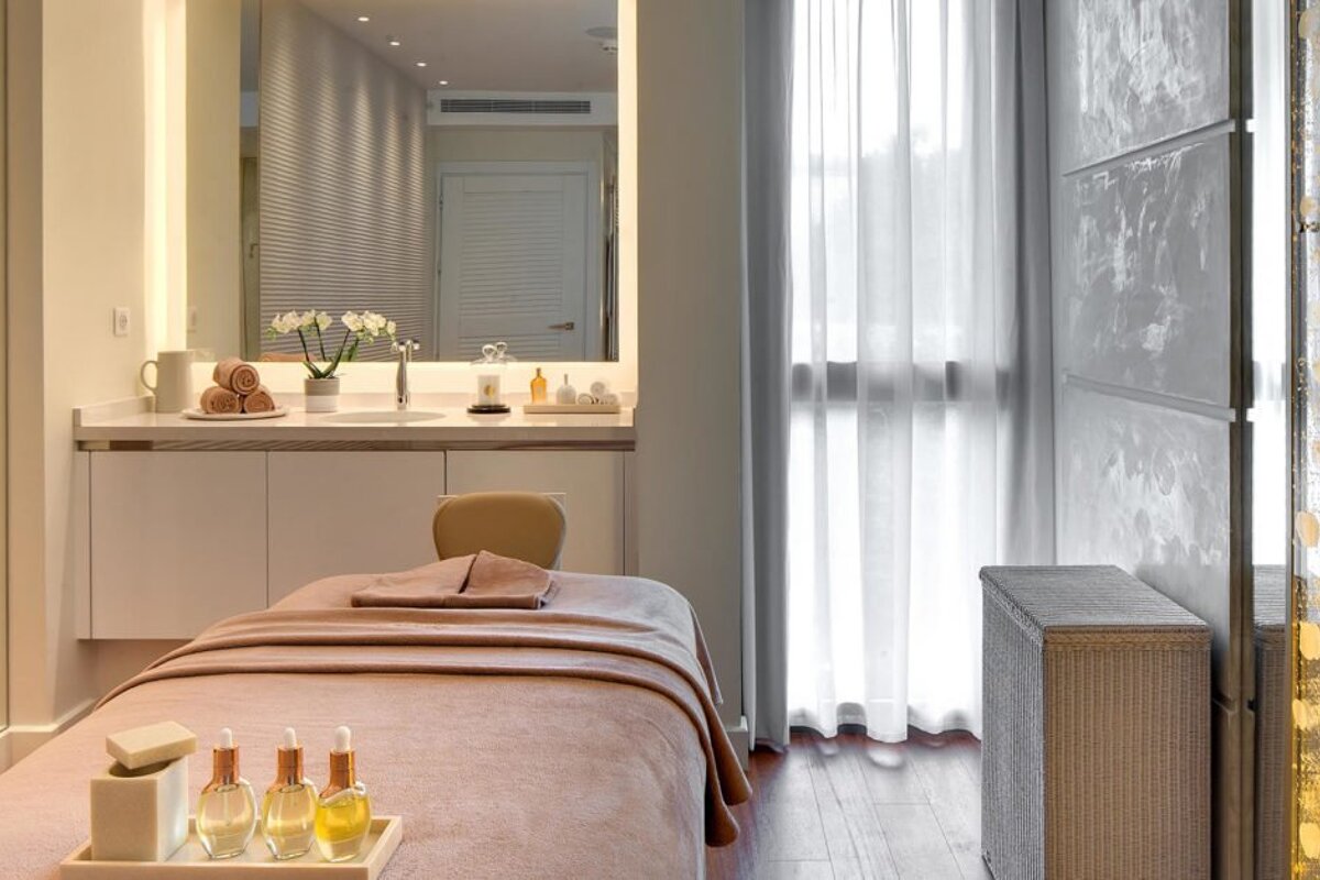 A room with a massage table and a sink