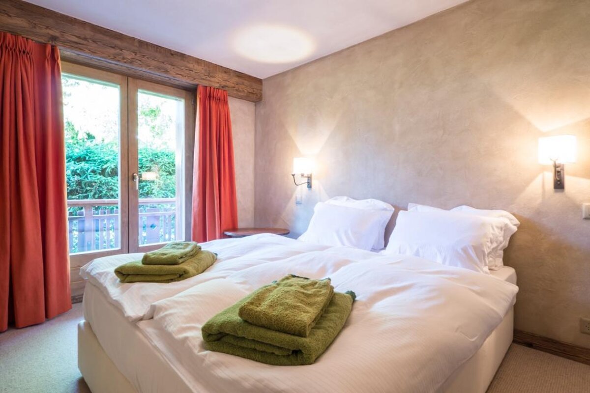 A hotel room with a bed and a window