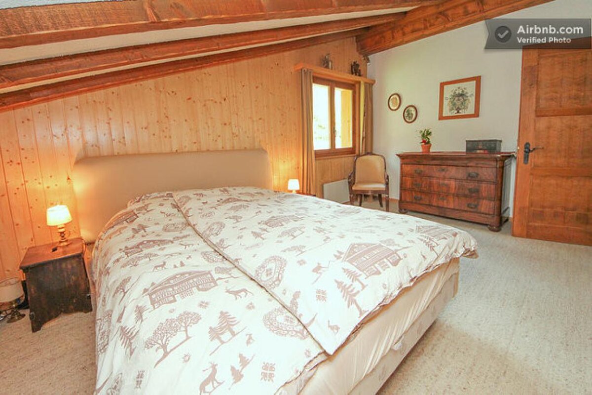 A bedroom with a bed and a dresser and an airbnb.com verified photo