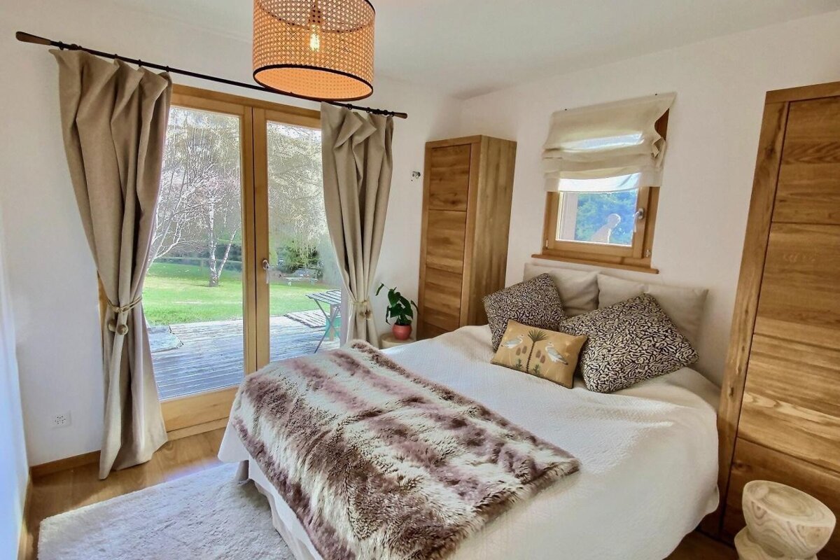 A bedroom with a bed and a sliding glass door