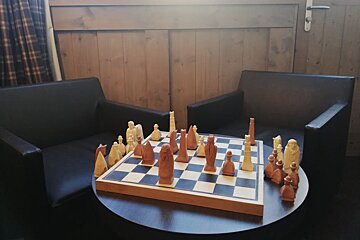 A round table with a chess board on it