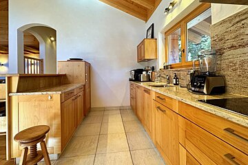 A kitchen with wooden cabinets and granite counter tops