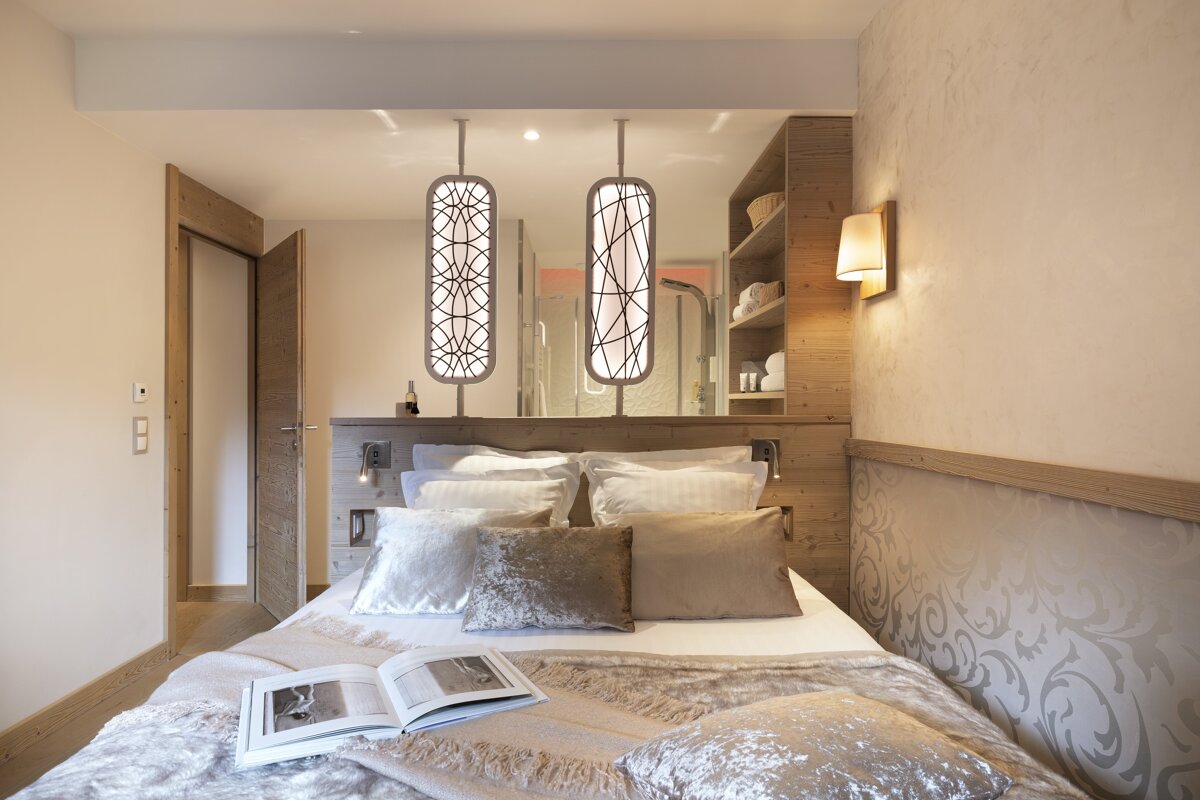 A bedroom with a bed and a book on it