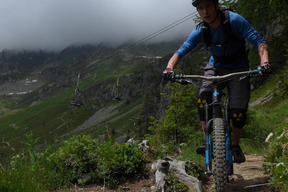 a mountain biker in the clouds on a mountain in chamonix