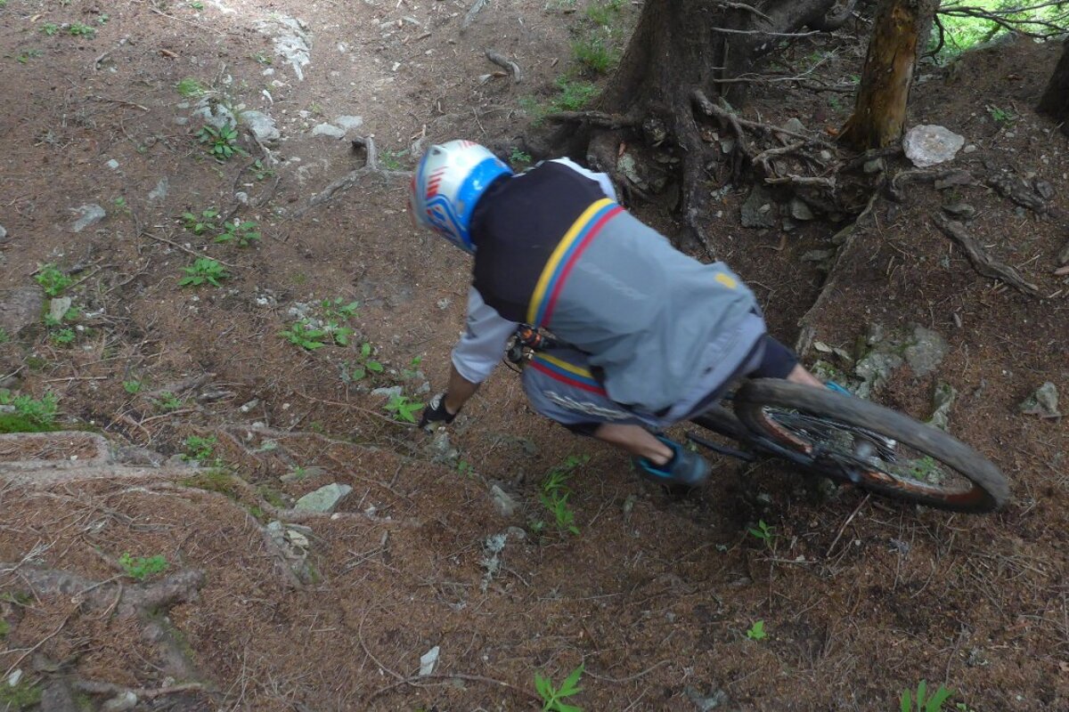 a mountain biker going down a steep section