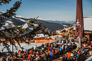 A group of people are sitting at tables in the snow