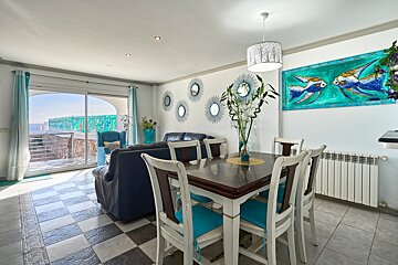 A living room with a dining table and chairs