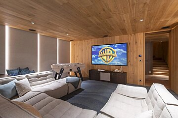 A home theater with a screen that says warner bros on it
