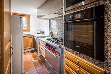 A bosch oven sits in a kitchen next to a stove