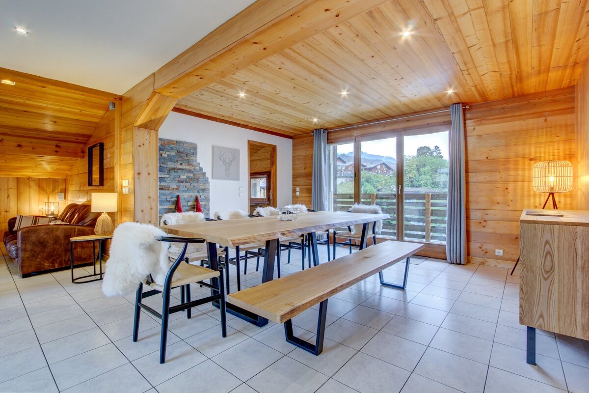 A dining room with a wooden table and chairs
