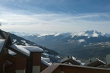 Chalets in the foreground with the valley and mountains in the background