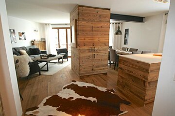 A living room with a cowhide rug on the floor