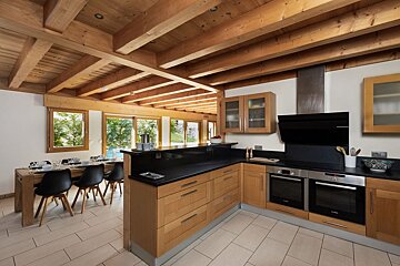 A kitchen with wooden cabinets and stainless steel appliances