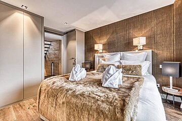 A bedroom with a fur blanket on the bed