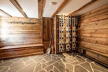 A room with wooden walls and a stone floor