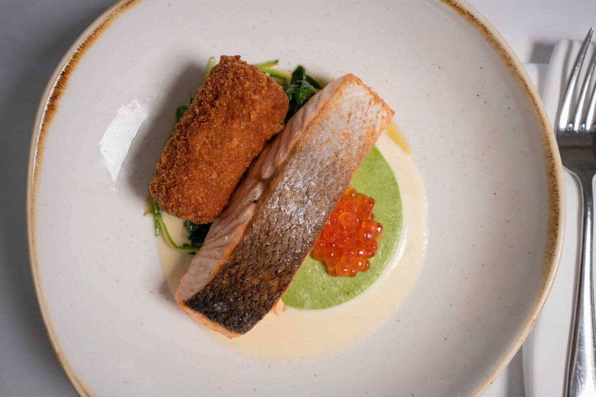 A close up of a plate of food with salmon and caviar
