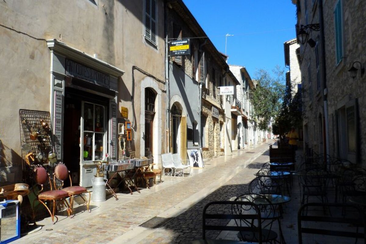 a narrow street with things for sale on it