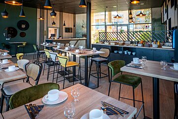 A restaurant with a lot of tables and chairs