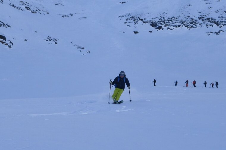 a skier in yellow pants